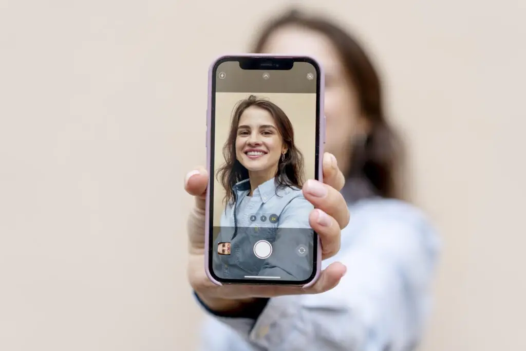 medium shot blurry woman holding phone